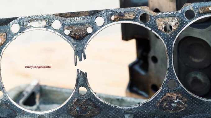 A damaged blown head gasket showing failure points.