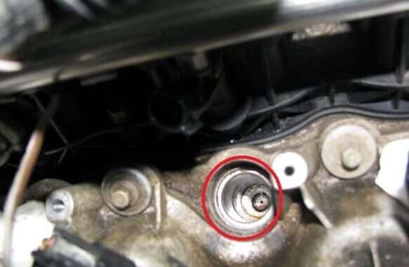 A broken plug shell stuck inside a vehicle's cylinder head.