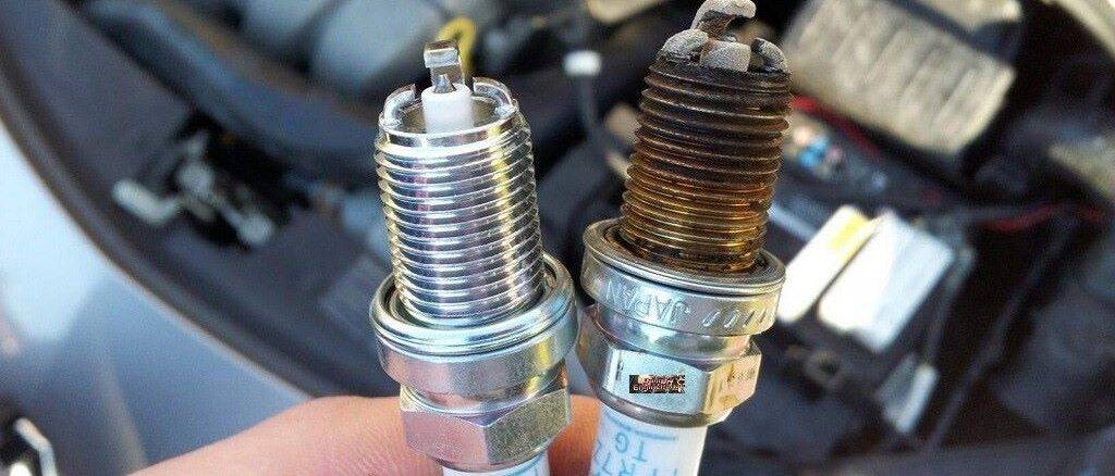 Comparing New And Old Spark Plug