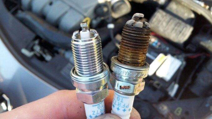 Comparing New And Old Spark Plug