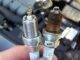 Comparing New And Old Spark Plug