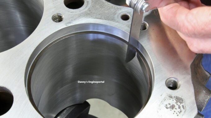 a ring inside a cylinder bore being measured with a metal feeler gauge