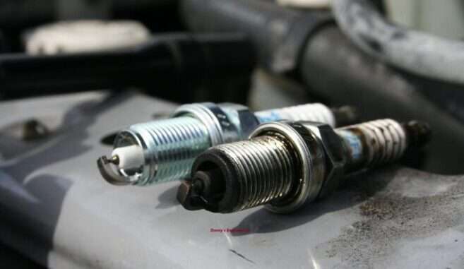 Spark Plug Comparison Side-by-side comparison of a clean new spark plug and a worn, carbon-fouled old plug.