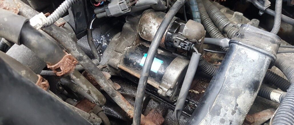 Car starter motor on engine