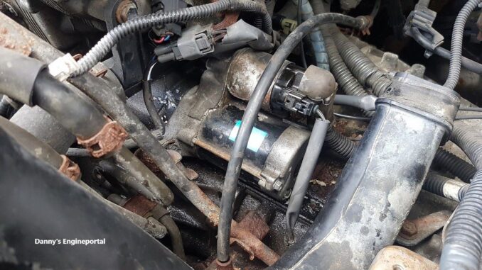 Car starter motor on engine