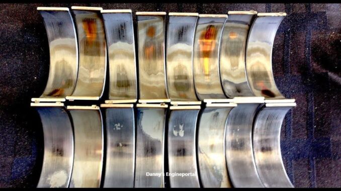 Comparison of a new engine bearing versus a worn, scored bearing from low oil pressure.