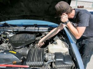 Using hose as a stethoscope to help pinpoint the vacuum leak source